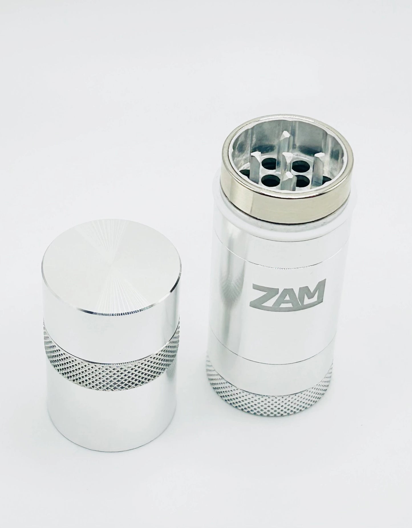 silver zam pocket grinder grinding chamber. Showing off long pointed teeth and no center post