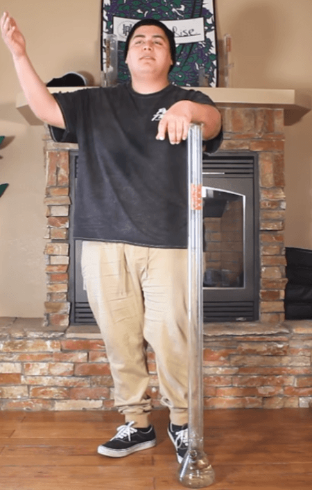 dope as yola standing next to zam 4 foot bong