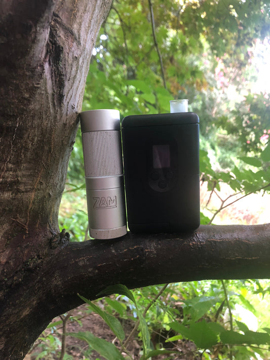 ZAM 1 inch pocket grinder sitting on a tree branch with the Argo next to it