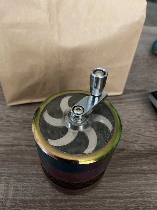 weed grinder with a metal crank on lid