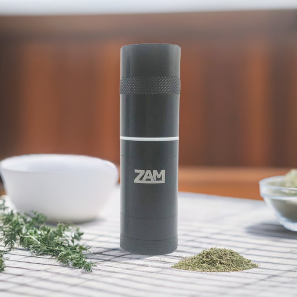 zam pocket aluminum grinder sitting on white table cloth