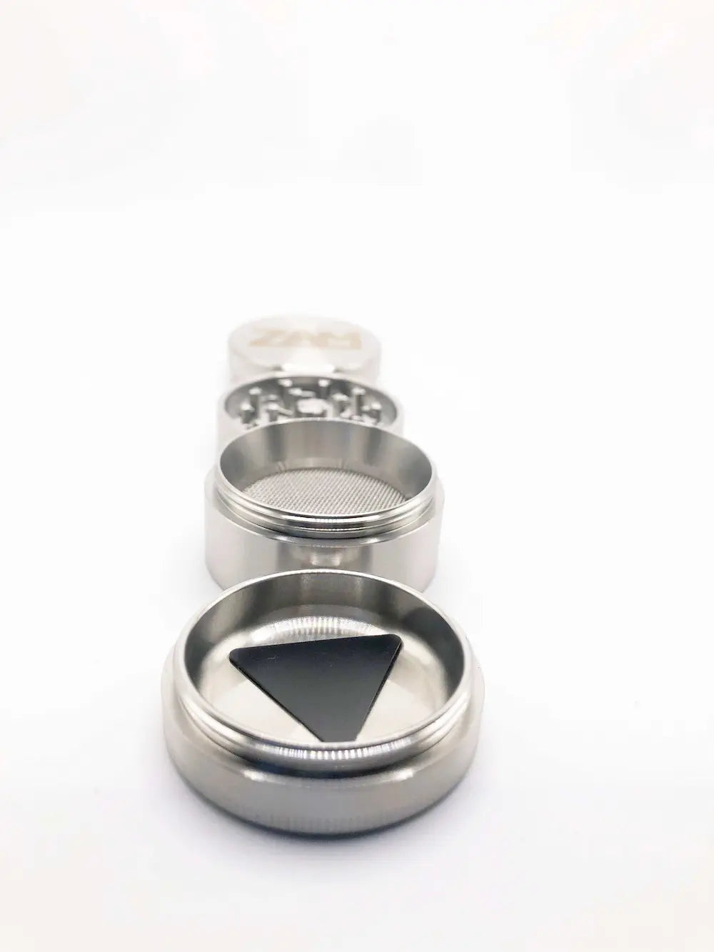 Small steel herb grinder with a deep curved pollen tray. Main storage has a screen.